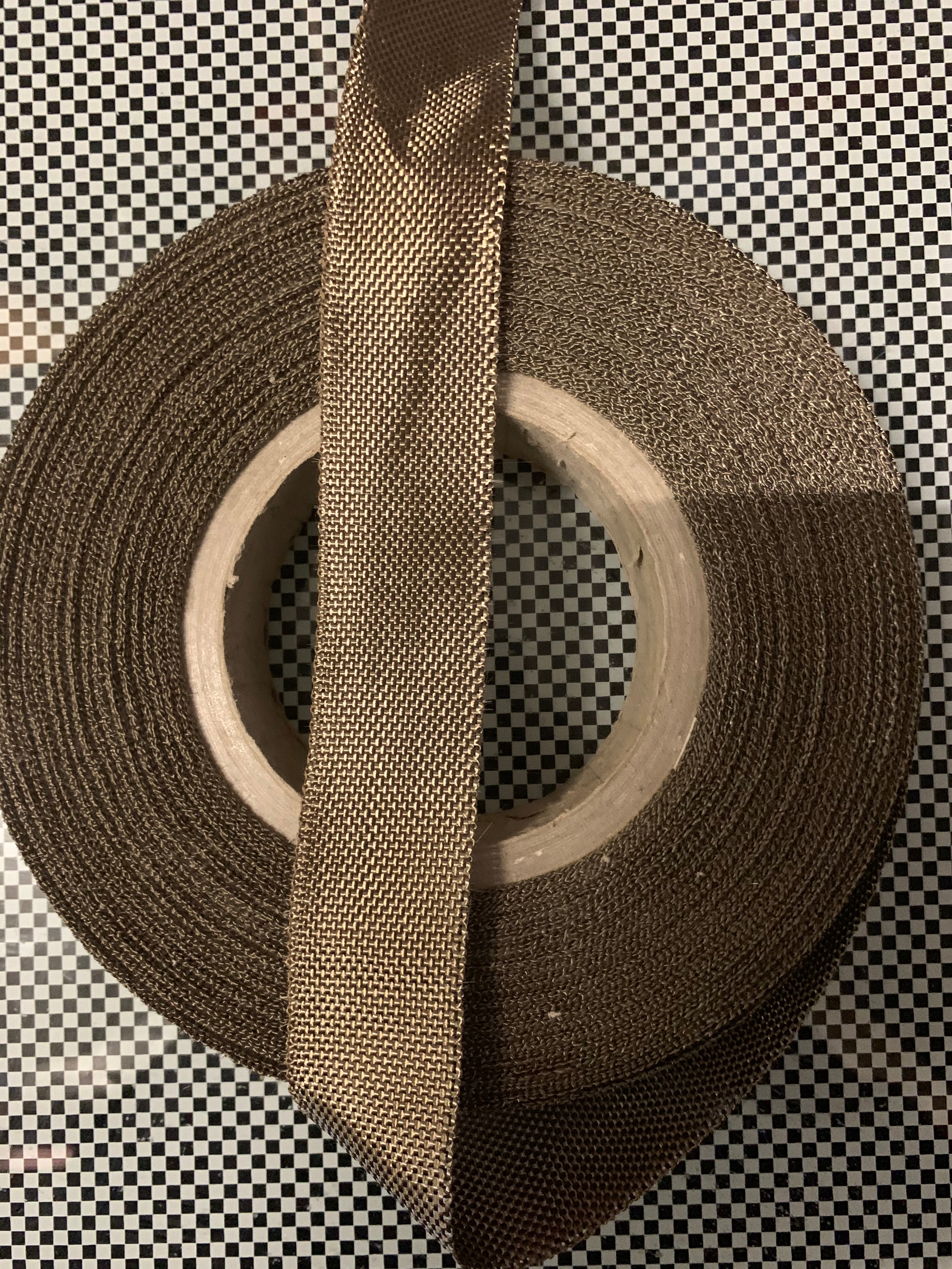 Basalt fiber tape, 30 mm, 0.21 mm, 11.3 g/m, one edge made of brown PP-yarn